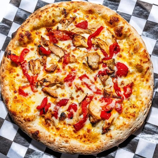 Bozzelli's chicken and roasted red pepper pizza on a checkered paper.