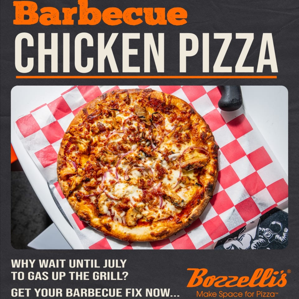A Bozzelli's Barbecue Chicken Pizza, topped with chicken, red onions, and melted cheese, on checkered paper.