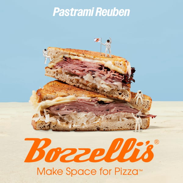 A Pastrami Reuben sandwich with melted cheese and sauerkraut, surrounded by tiny astronaut figures.